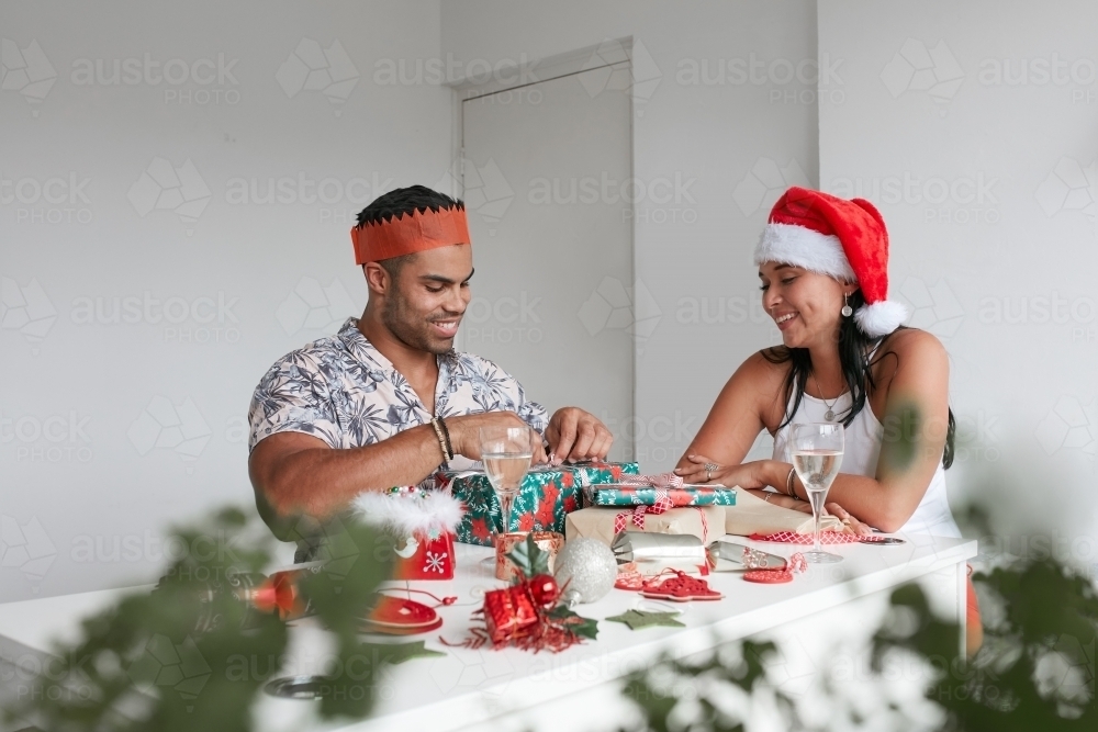 Young couple celebrating Xmas lunch together - Australian Stock Image