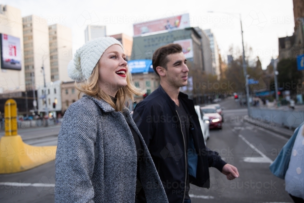 Young Couple Crossing the Road in Melbourne City - Australian Stock Image
