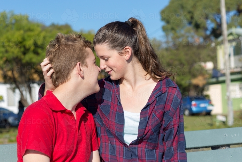 Young couple in intimate moment outdoors - Australian Stock Image