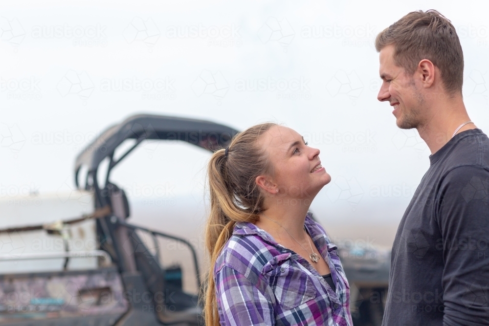 Young couple looking at each other with smoke in background - Australian Stock Image