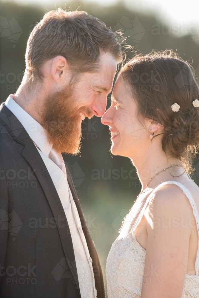 Young couple on wedding day looking into each others eyes. - Australian Stock Image