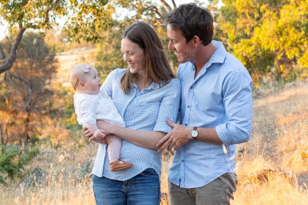 Young couple outdoors with their baby girl - Australian Stock Image
