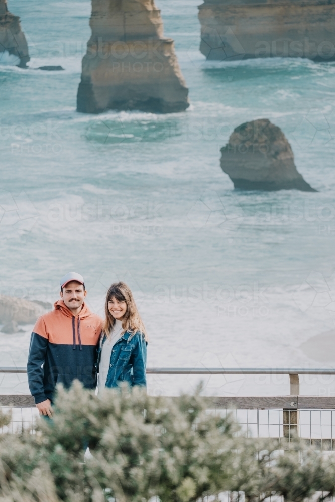 Young couple pose at a tourist destination. - Australian Stock Image