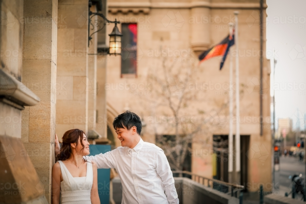 Young couple posing together outside St Paul's Cathedral in Melbourne - Australian Stock Image