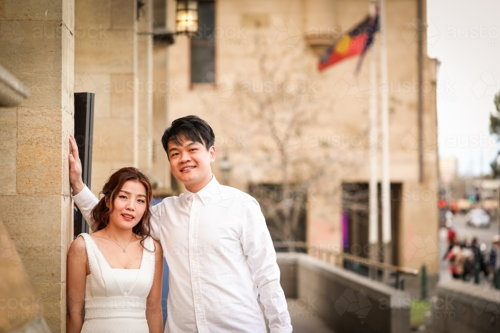 Young couple posing together outside St Paul's Cathedral in Melbourne - Australian Stock Image