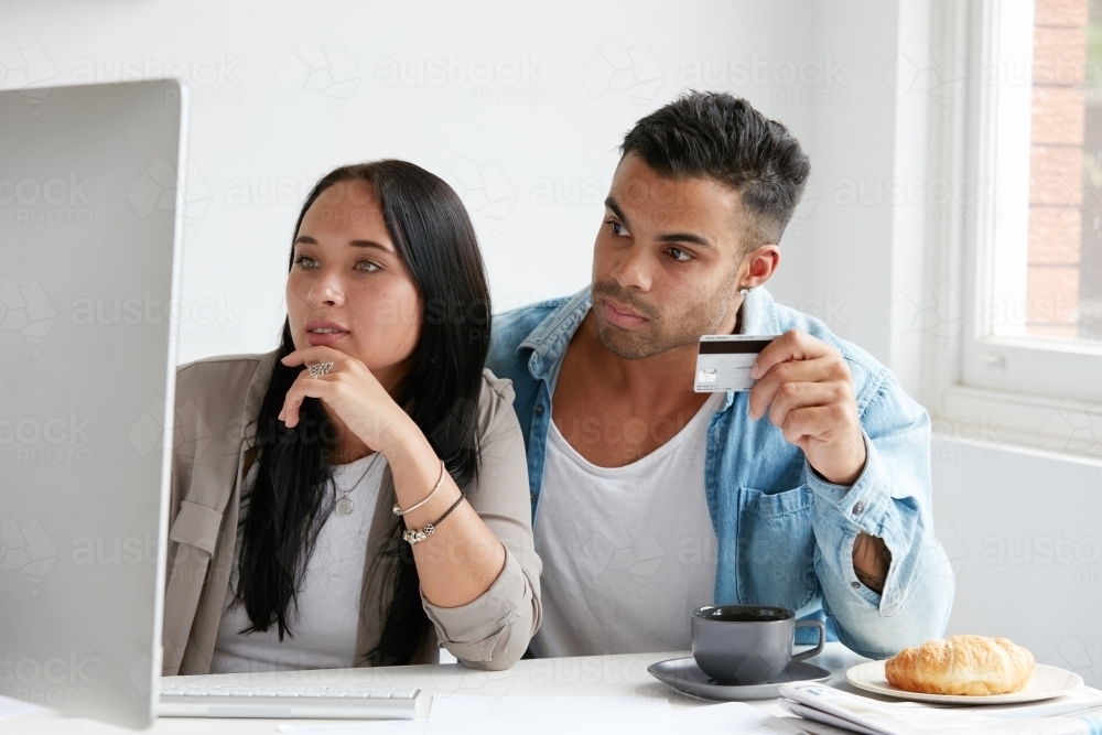 Young couple shopping online - Australian Stock Image