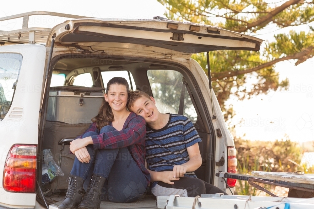Young couple sitting on back of 4WD - Australian Stock Image