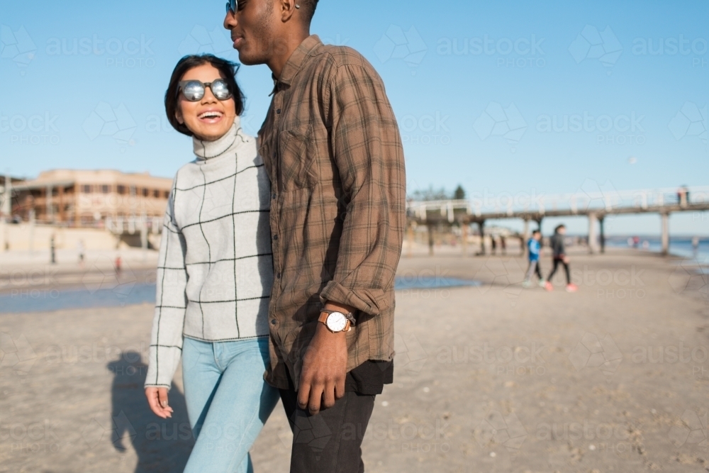 Young couple walking together on the beach - Australian Stock Image
