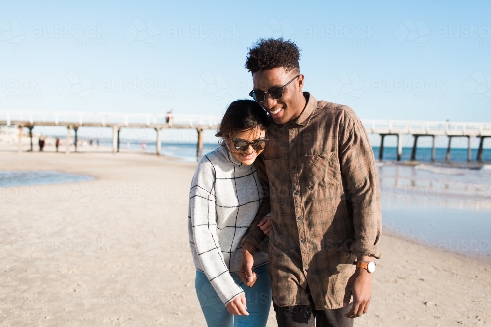 Young couple walking together on the beach - Australian Stock Image