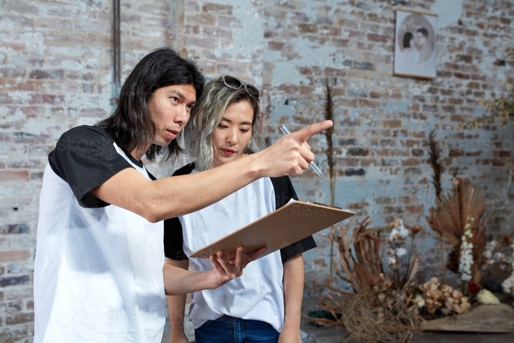 Young event planners working together on set - Australian Stock Image