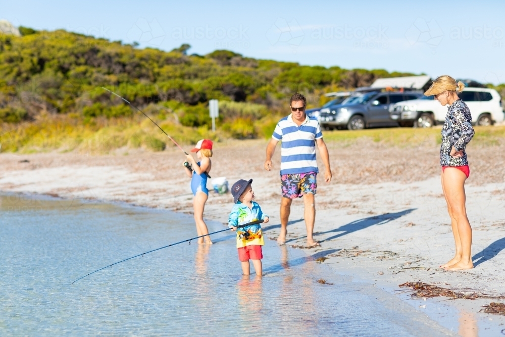 young family fishing on beach holiday - Australian Stock Image