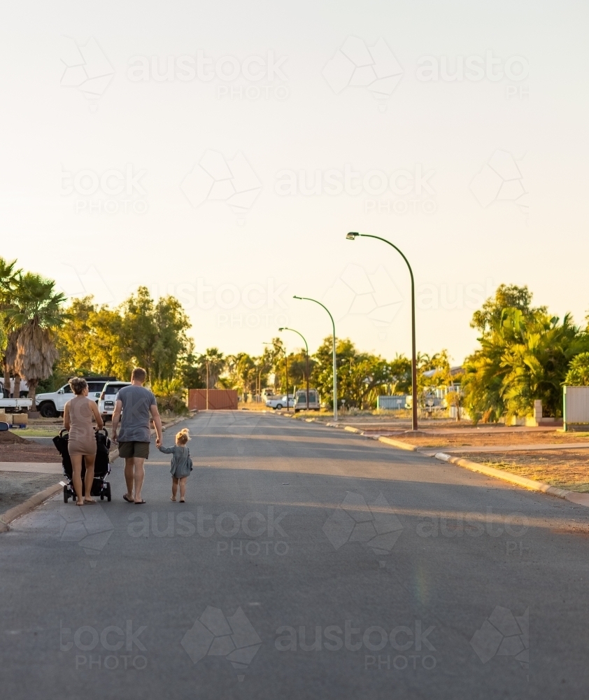 young family from behind on suburban street in Karratha - Australian Stock Image