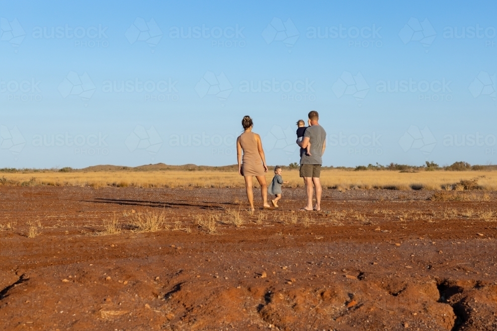young family outdoors in the Pilbara, seen from behind - Australian Stock Image