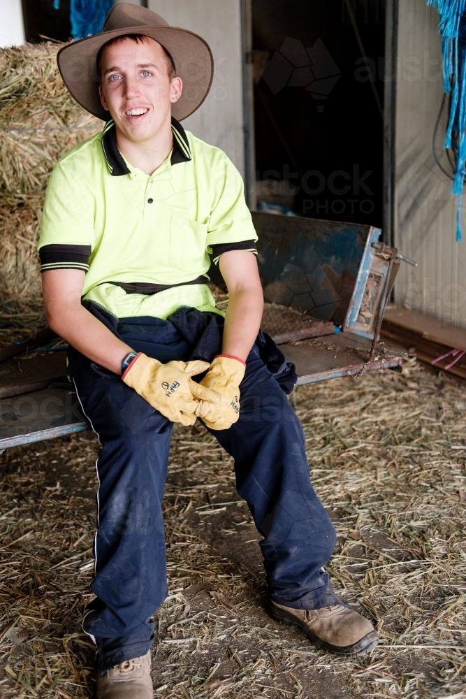 Young Farmer Seated in a Shed - Australian Stock Image
