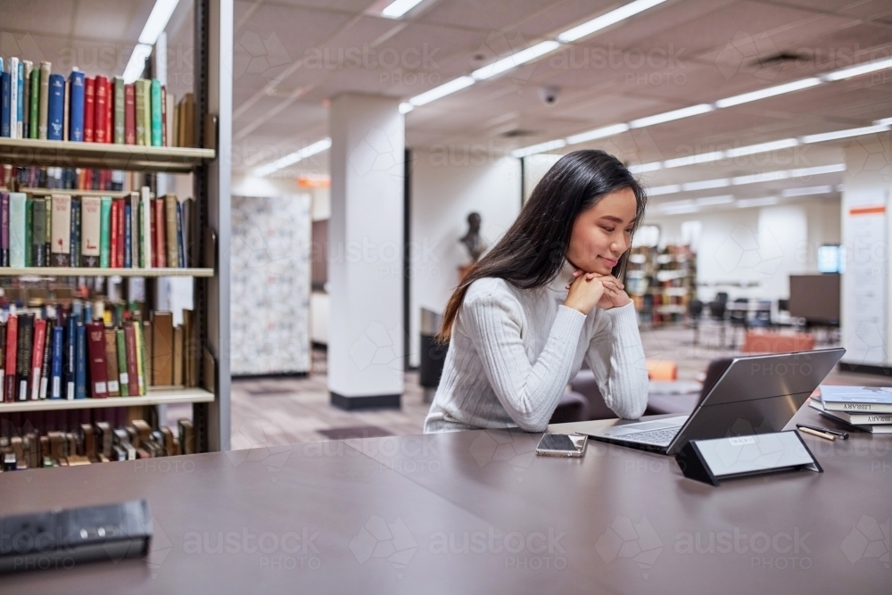 Image of Young female Asian student working on her laptop at university ...
