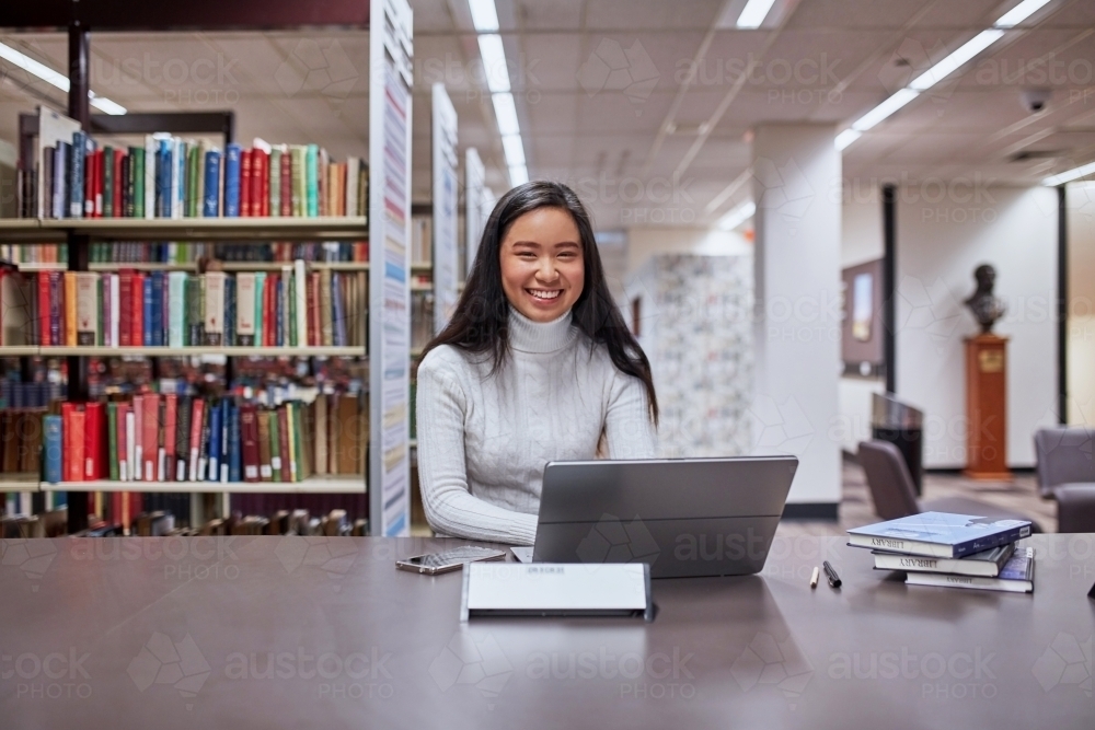 Image of Young female Asian student working on her laptop at university ...