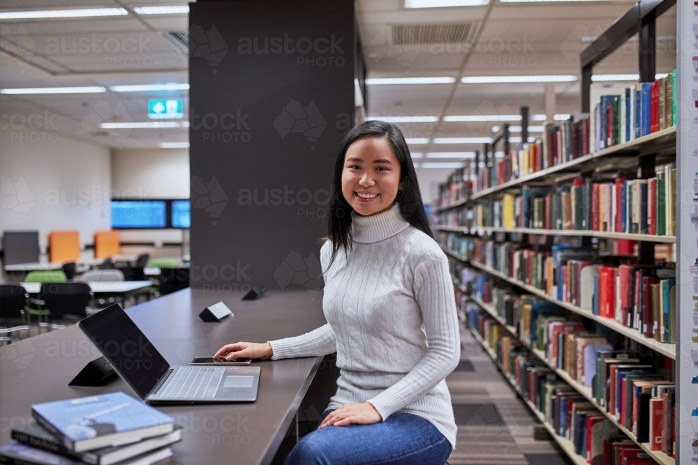 Image of Young female Asian student working on laptop at university ...