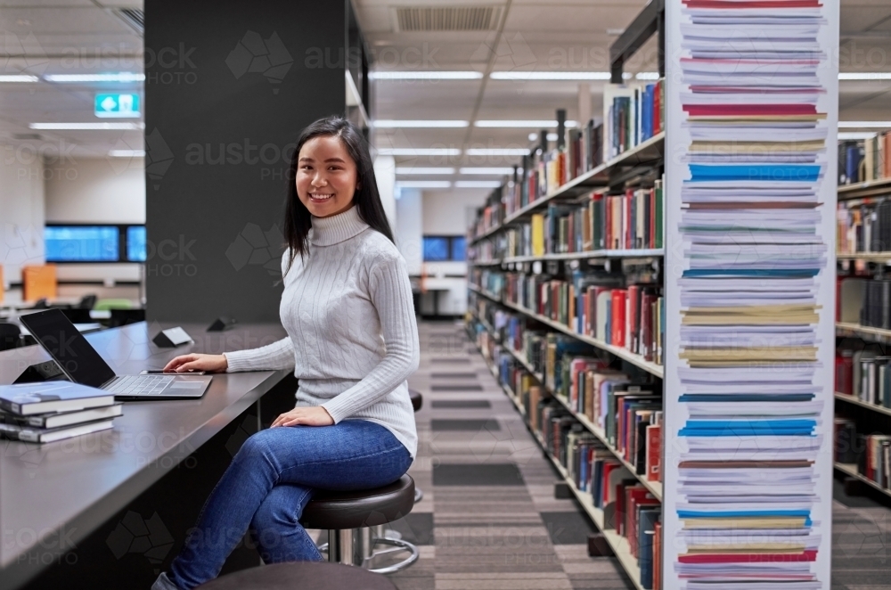 Image of Young female Asian student working on laptop at university ...