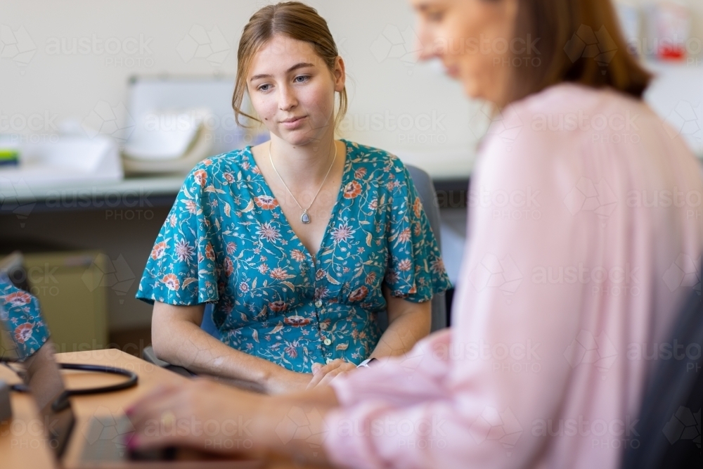 young female at medical appointment in doctors surgery - Australian Stock Image