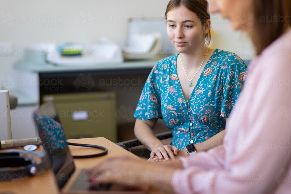 Young female at medical appointment in doctors surgery - Australian Stock Image