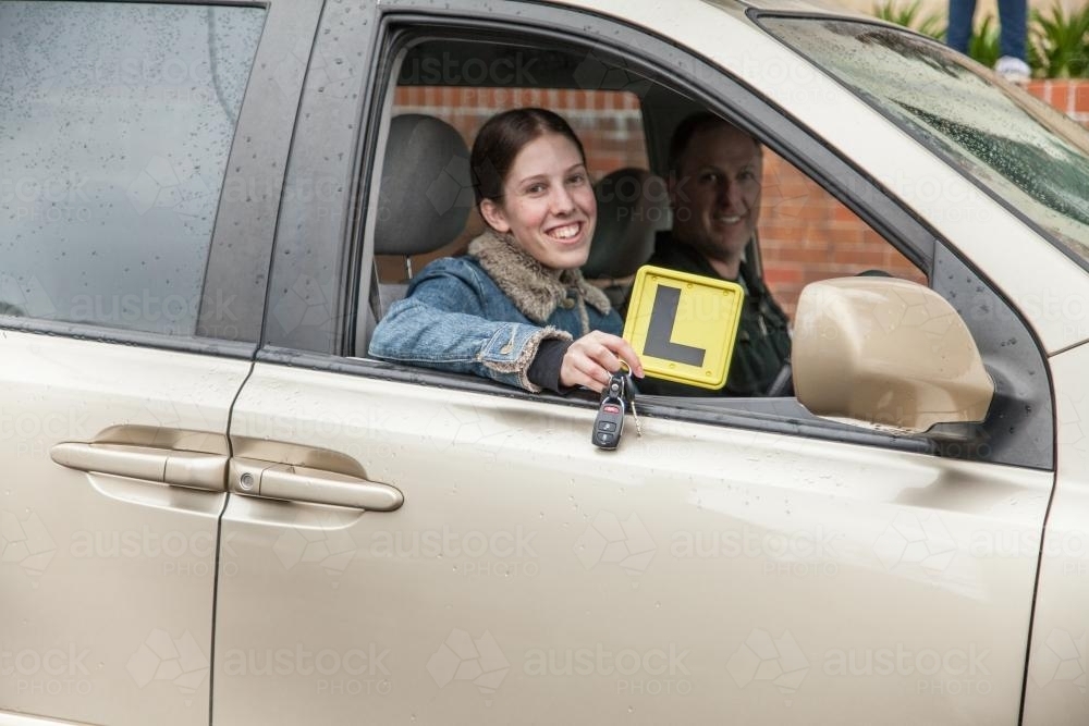 Young female learner driver being supervised by her father - Australian Stock Image