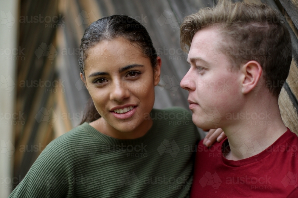 Young Fijian woman leaning on Caucasian male partner - Australian Stock Image
