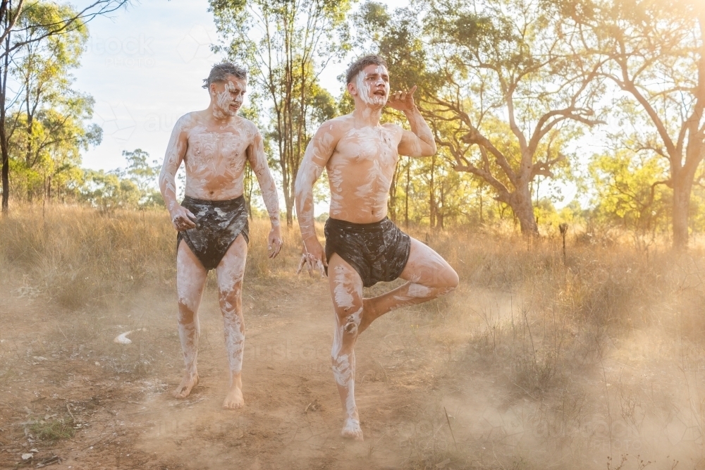 Young first nations australian men telling traditional aboriginal stories through dance - Australian Stock Image
