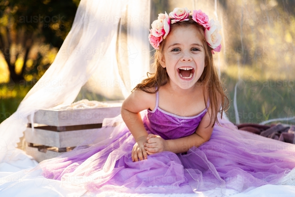 Young girl dressed as a princess laughing - Australian Stock Image