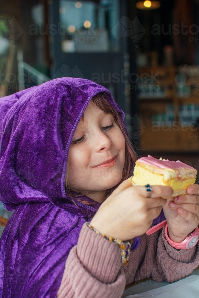 Young girl eating vanilla slice - Australian Stock Image
