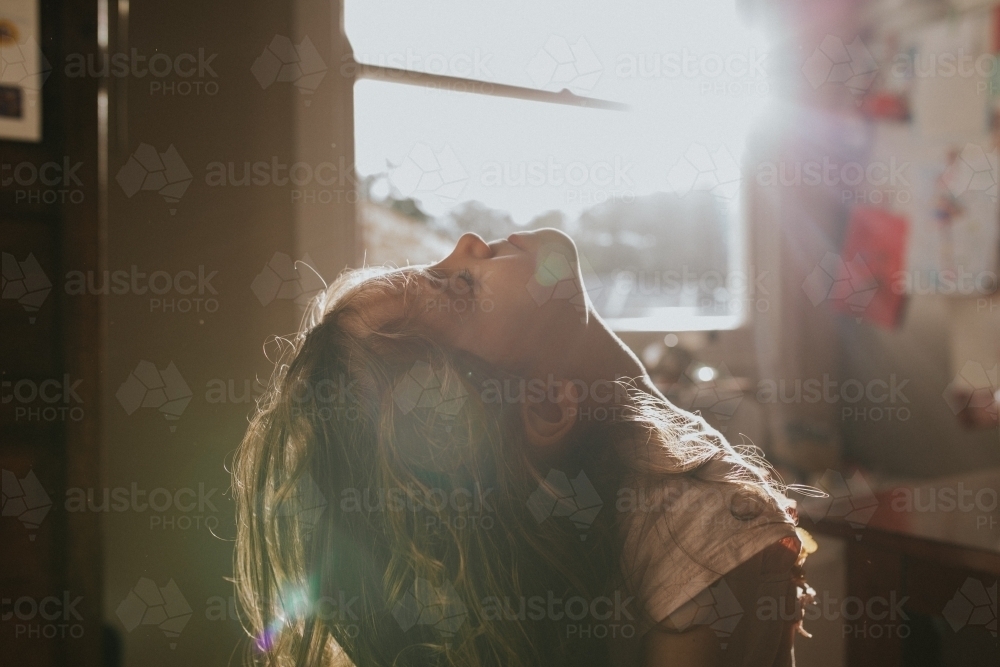 Young girl enjoying the sun on her face - Australian Stock Image