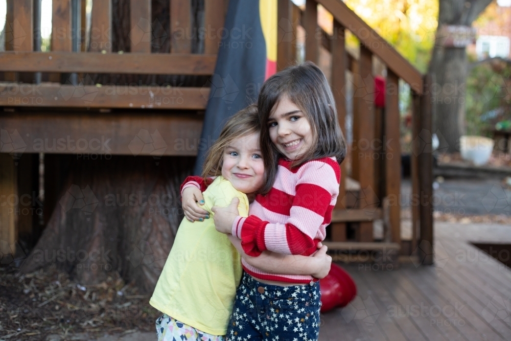 Young girl friends hugging - Australian Stock Image