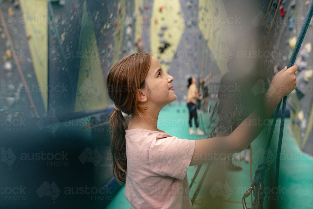 Young girl holding the rope for rock-climbing - Australian Stock Image