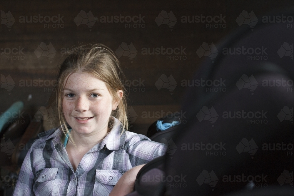 Young girl in dark shed - Australian Stock Image