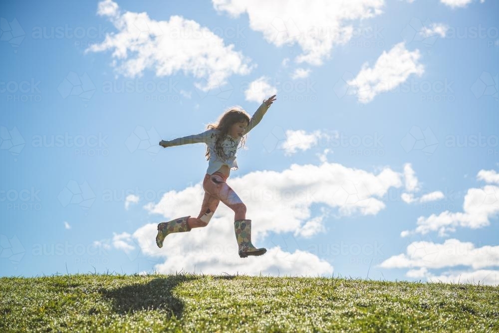 Young girl leaping - Australian Stock Image