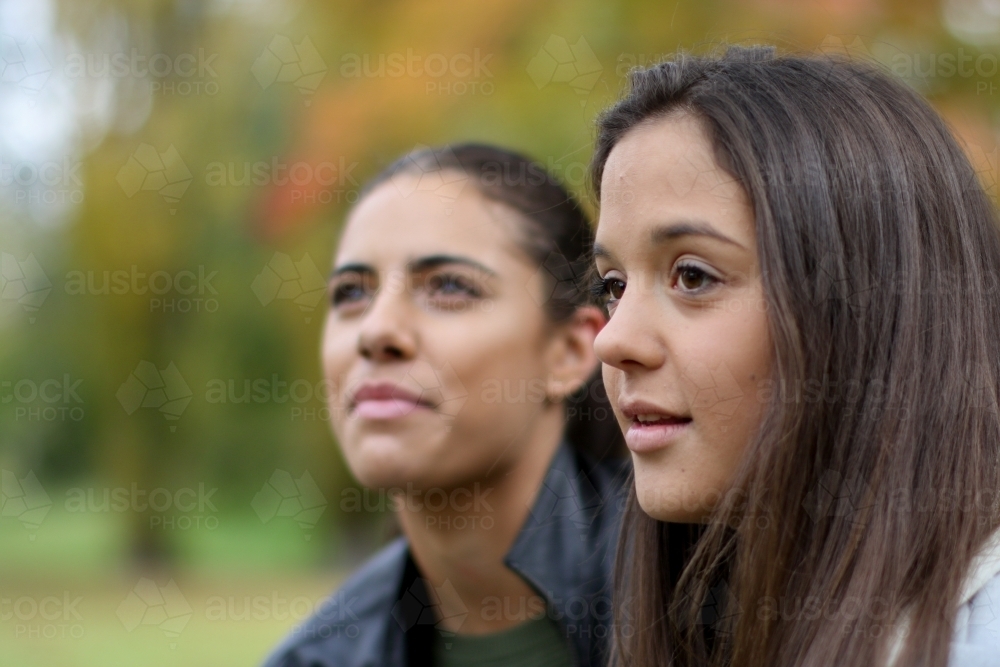 Young girl looking into the distance with girl in the background - Australian Stock Image