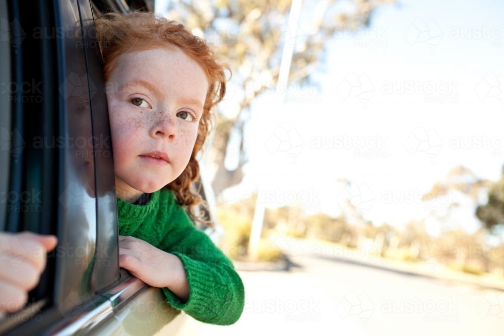 Young girl looking out of a car window - Australian Stock Image