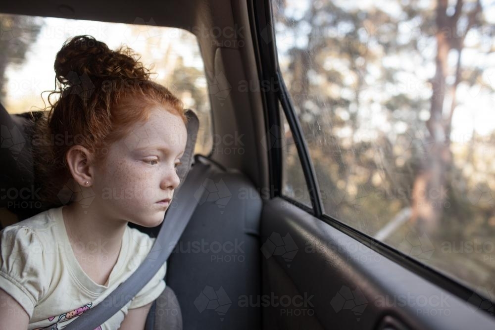 Young girl looking out of the car window - Australian Stock Image