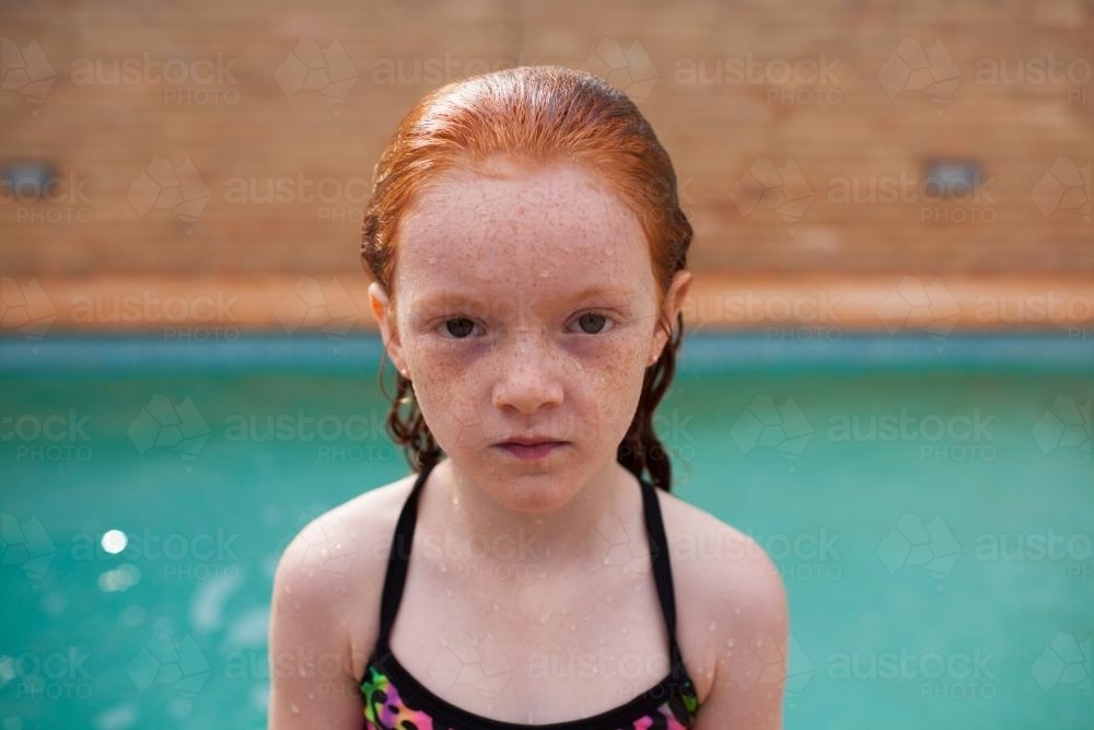 Young girl looking serious after a swim - Australian Stock Image
