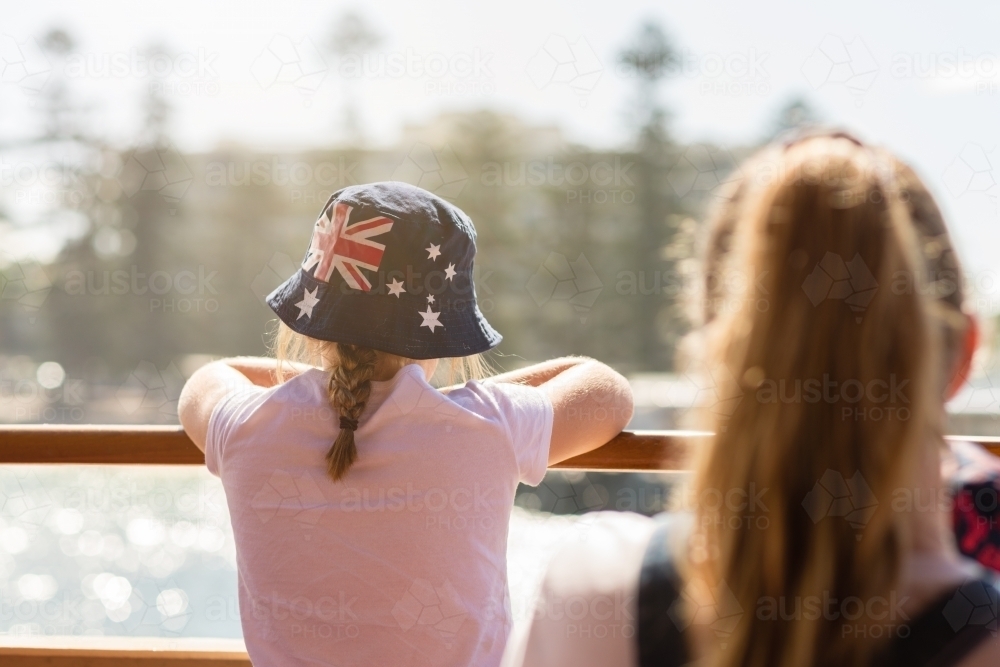 young girl on ferry to Manly, wearing an Aussie flag sun hat - Australian Stock Image
