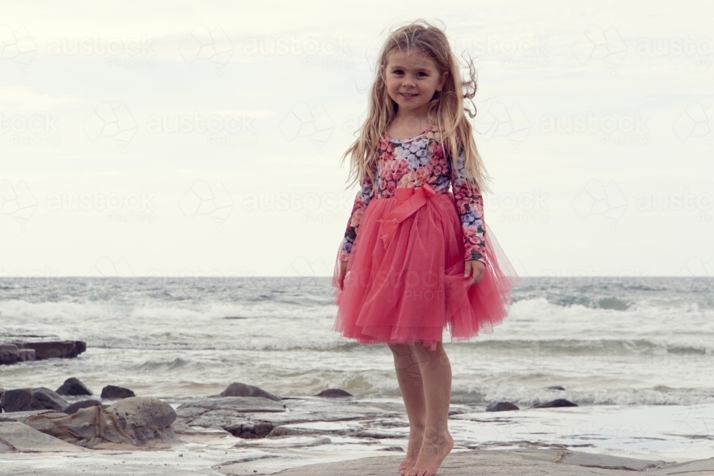Young girl on overcast beach - Australian Stock Image