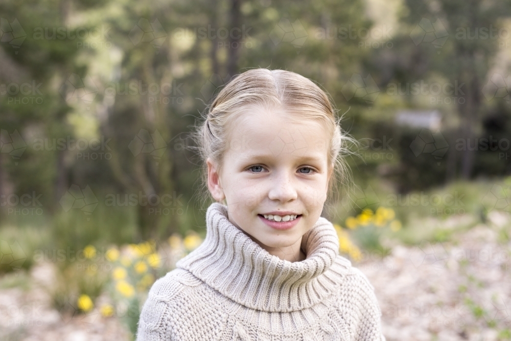 Young girl outdoors, smiling - Australian Stock Image