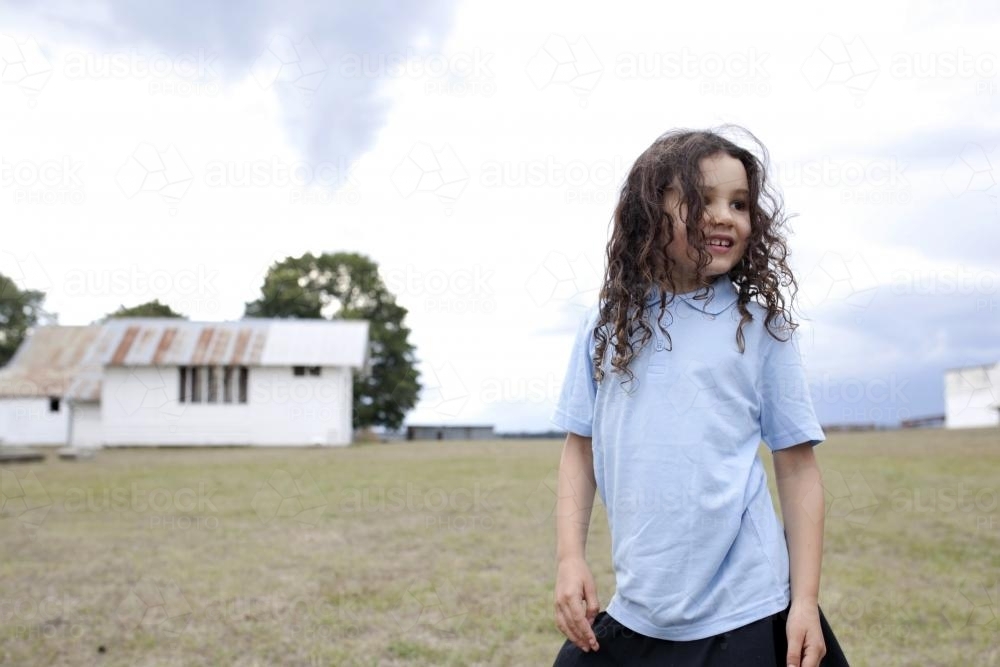 Young girl outside wearing school uniform - Australian Stock Image