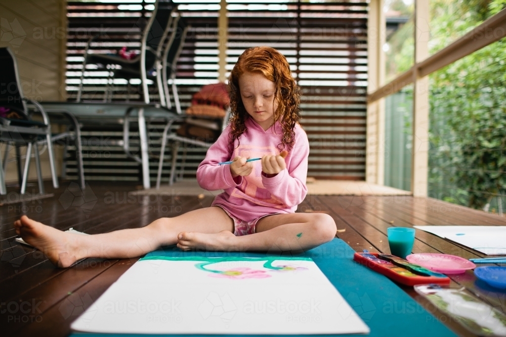 Young girl painting a picture - Australian Stock Image