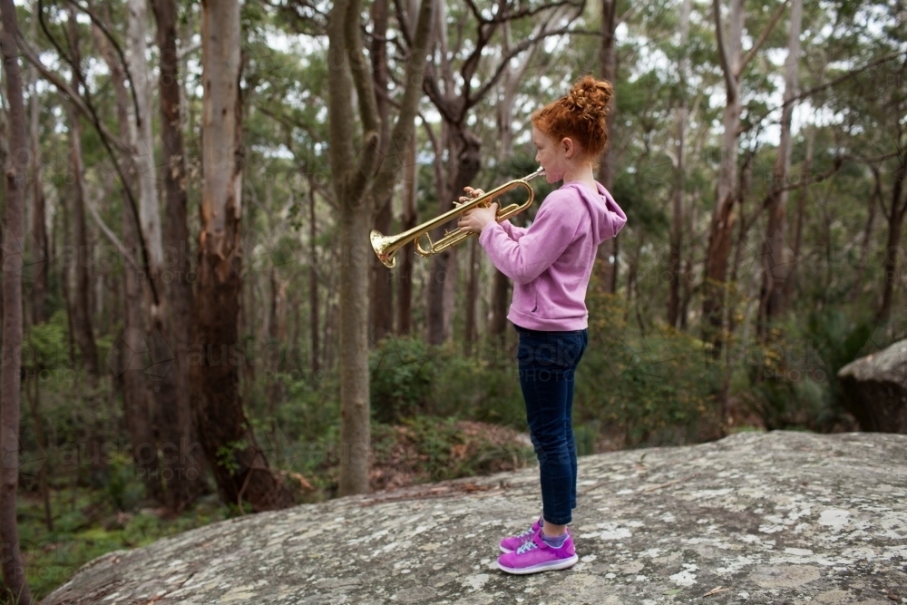 Young girl playing a trumpet - Australian Stock Image