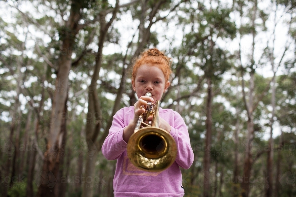 Image of Young girl playing a trumpet - Austockphoto
