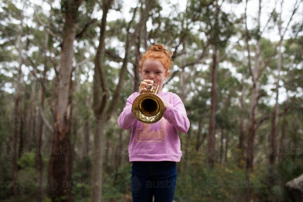 Young girl playing a trumpet - Australian Stock Image