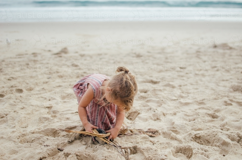 Young girl playing at the beach - Australian Stock Image