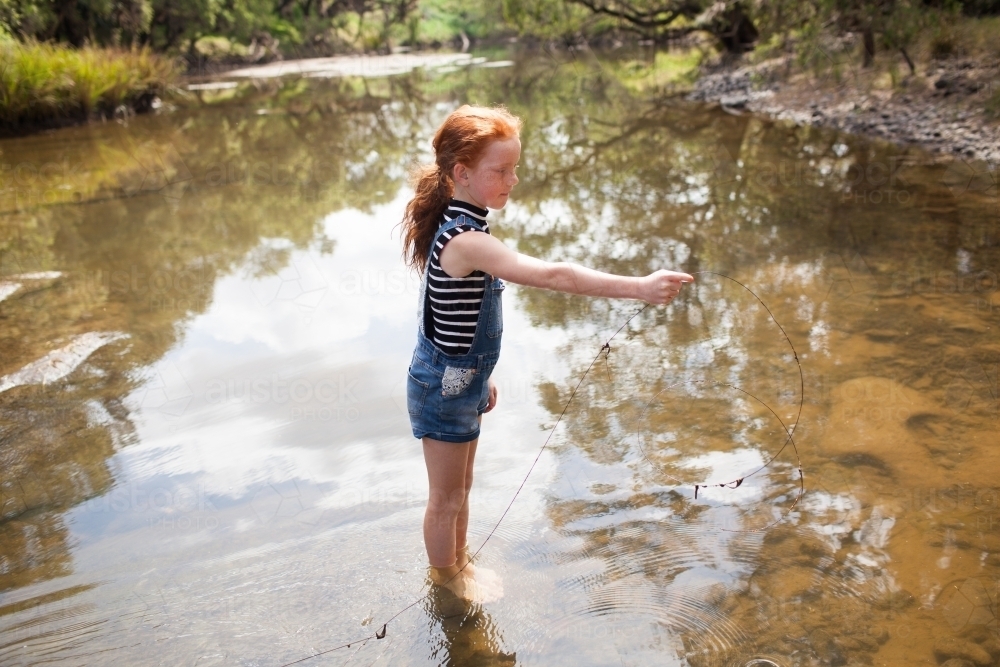Young girl playing in the river - Australian Stock Image