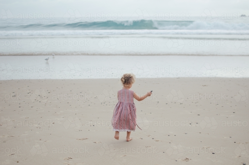 Young girl playing on a beach - Australian Stock Image