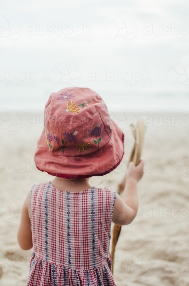 Young girl playing on a beach - Australian Stock Image